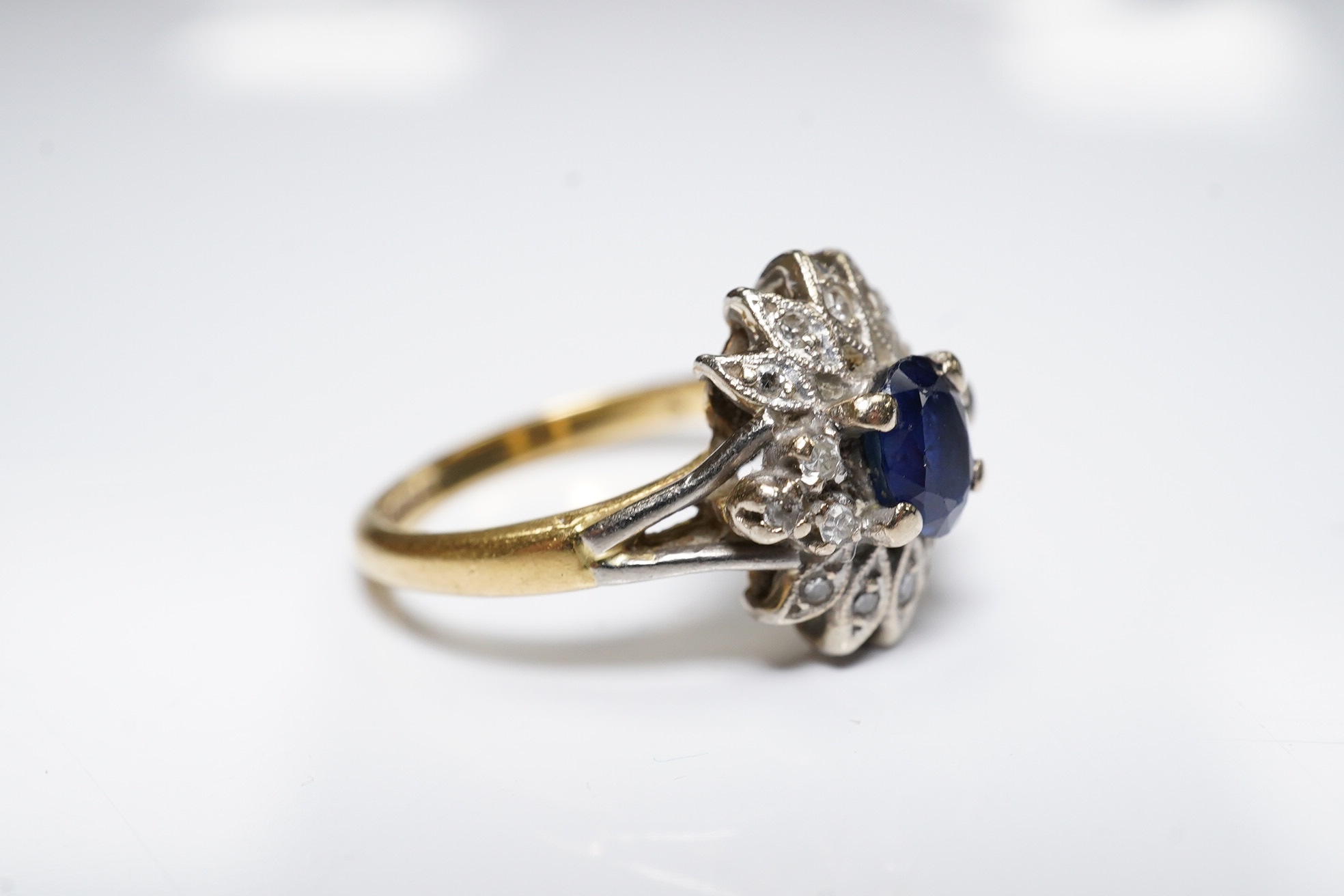 A modern 18ct gold, sapphire and diamond cluster set ring, size M/N, gross weight 4.6 grams. Condition - poor to fair